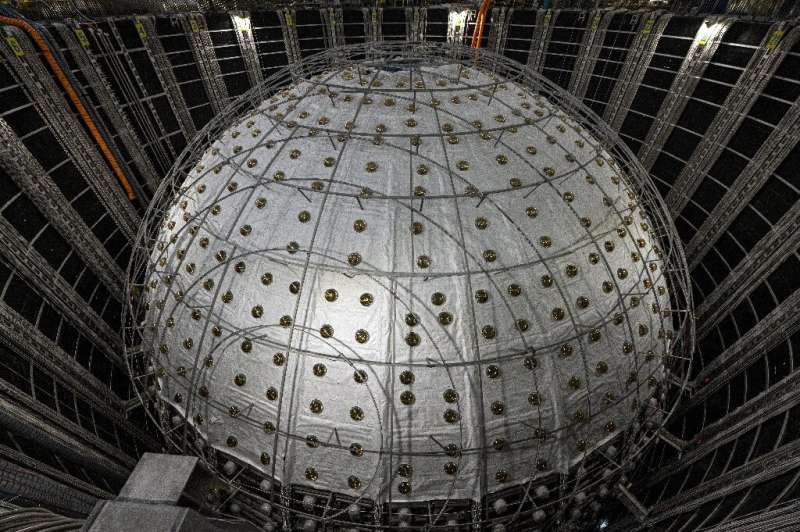 Inside stands the neutrino detector, a stainless steel and acrylic sphere around 35 metres in diameter, crisscrossed by cables