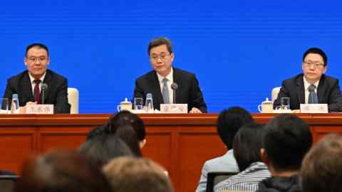 China’s finance minister Lan Fo’an, flanked by his deputies, speaks at a press conference in Beijing