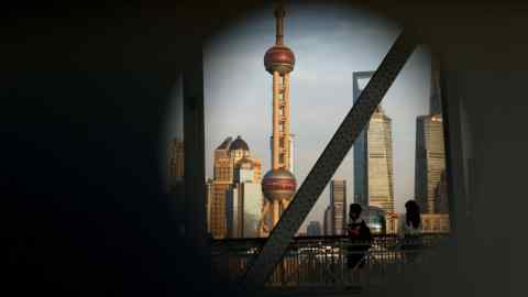 The financial district of Pudong in Shanghai, China, is visible through a circular hole on a bridge. The scene includes the Oriental Pearl Tower and other skyscrapers