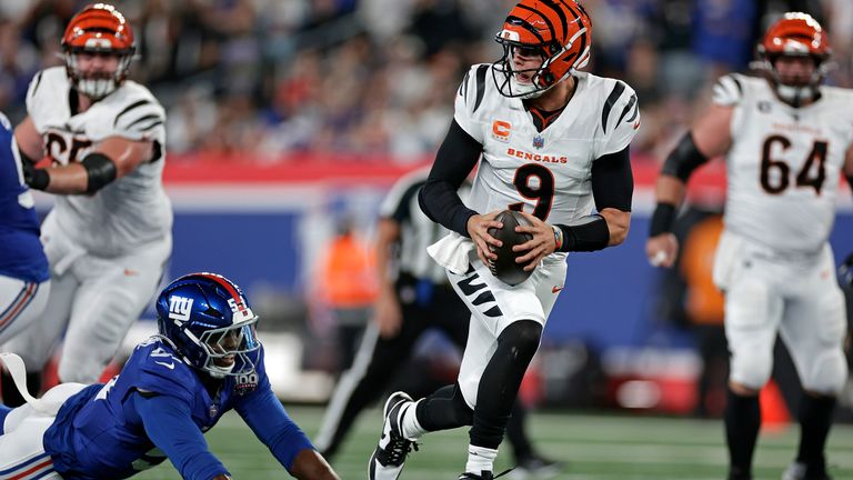 Cincinnati Bengals quarterback Joe Burrow (9) runs for a touchdown past New York Giants linebacker Azeez Ojulari