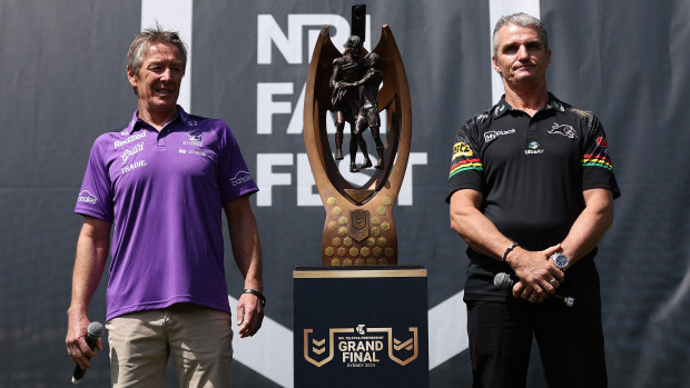 Craig Bellamy, coach of the Storm and Ivan Cleary, coach of the Panthers, pose alongside the Provan-Summons Trophy.