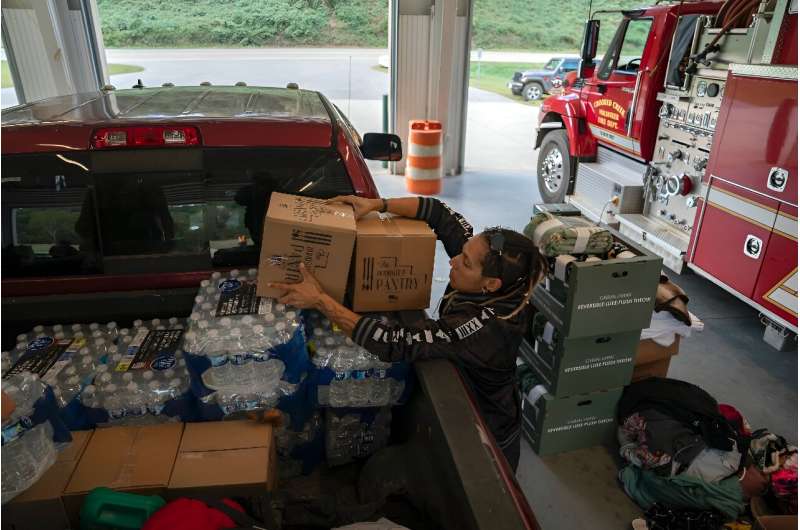 A volunteer unloads relief supplies in North Carolina on October 3, 2024, after the passage of Hurricane Helene made drinking water a valuable commodity