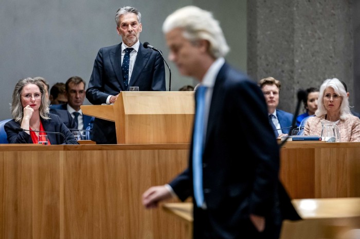 Prime Minister Dick Schoof looks on as Geert Wilders walks during the government statement in the plenary hall of the House of Representatives in The Hague