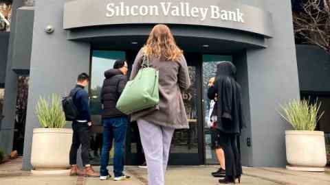 People stand outside the entrance of a Silicon Valley Bank branch in Santa Clara, California