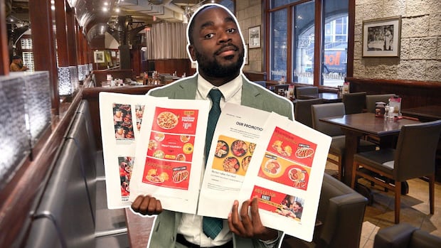 In foreground, CBC's Kwabena Oduro holds papers showing restaurant discounts, in background, a restaurant dining room