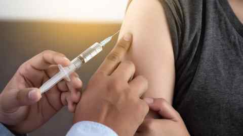 A doctor gives a patient a vaccination