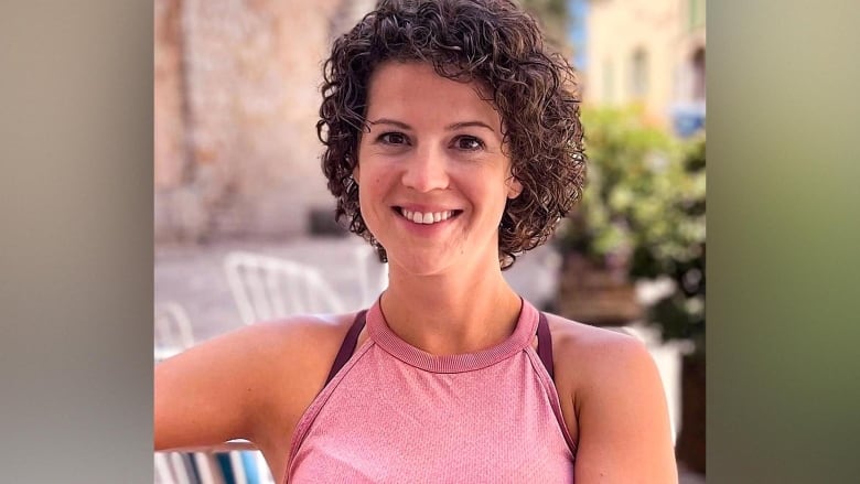 A smiling woman with curly hair