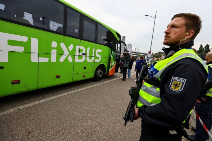 A German police officer stands guard next to a bus at a border with France in Kehl, Germany on September 16