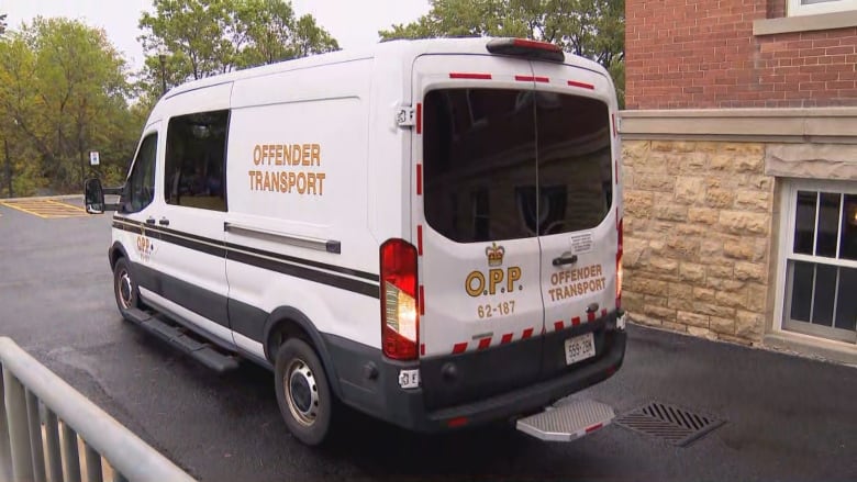 A white van marked "prisoner transport" in bold letters