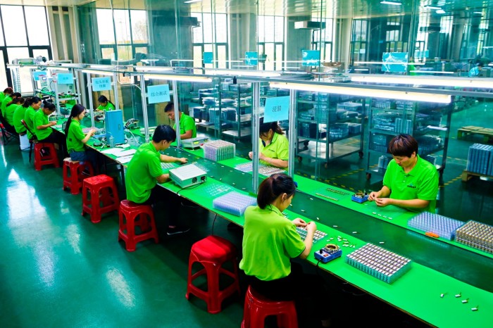 Employees carry out final checks on lithium batteries at a new energy technology enterprise in Nanyang, China