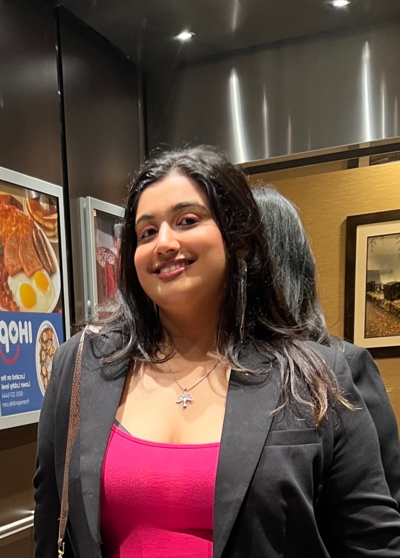 A young woman smiling and posing for the camera.