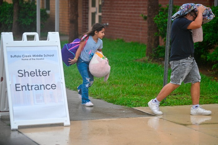 People arriving to shelter at a school ahead of Hurricane Miton’s expected landfall in Florida, US on October 9 2024