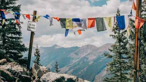 Prayer flags at the edge of the winter ski area on Aspen Mountain in Colorado