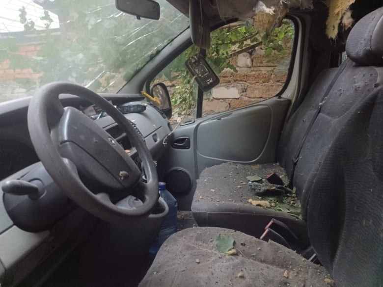 The interior of a car that was damaged after it was hit by explosives dropped from a Russian drone in Kherson, Ukraine.