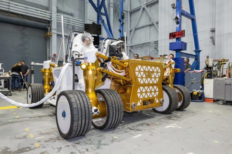 Suited NASA Engineers Sit on Rover Prototype