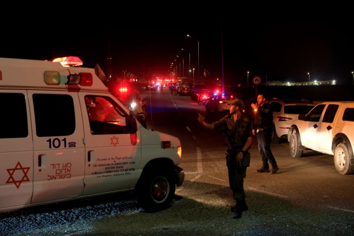 Emergency services personnel attend the scene of a drone strike on October 13, 2024 in Binyamina, Israel. 