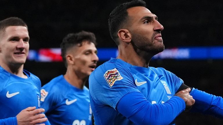 Greece's Evangelos Pavlidis celebrates scoring their side's first goal of the game against England by pointing to his black armband by way of tribute to the late George Baldock