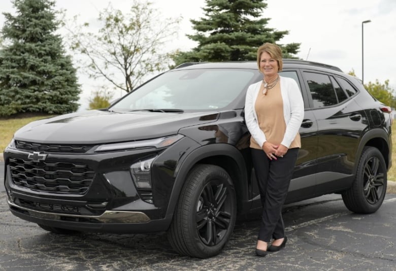 Michelle Chumley poses for a portrait beside her new Chevrolet Trax compact SUV, Thursday Sept. 26, 2024, in West Chester, OH.