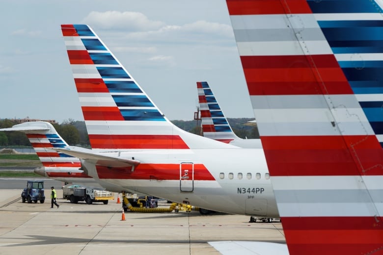 Several grounded plans are shown on an airport runway.