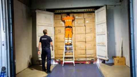 Customs officers inspect a container at Antwerp port