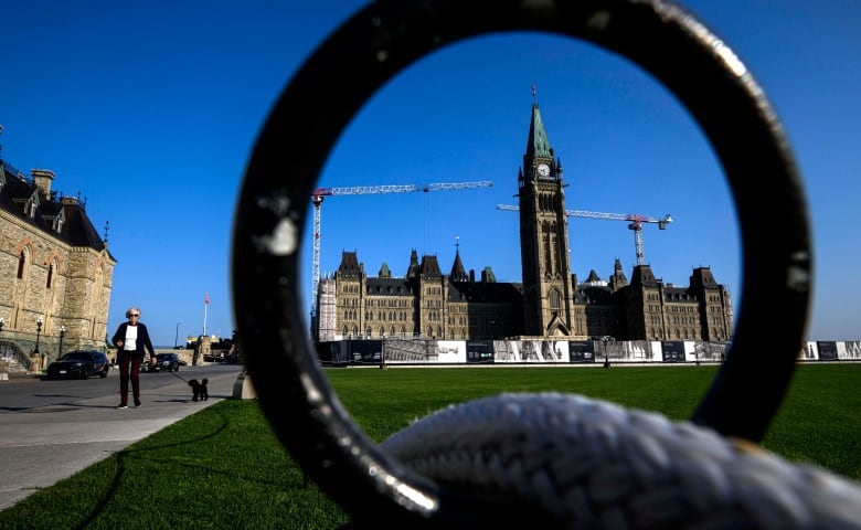 A legislature seen through the ring of a fence on a summer day.