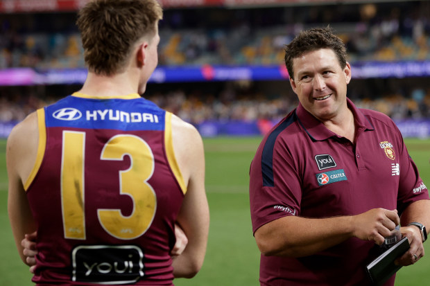 Logan Morris of the Lions and Brisbane Lions assistant Stuart Dew during the finals, 2024.