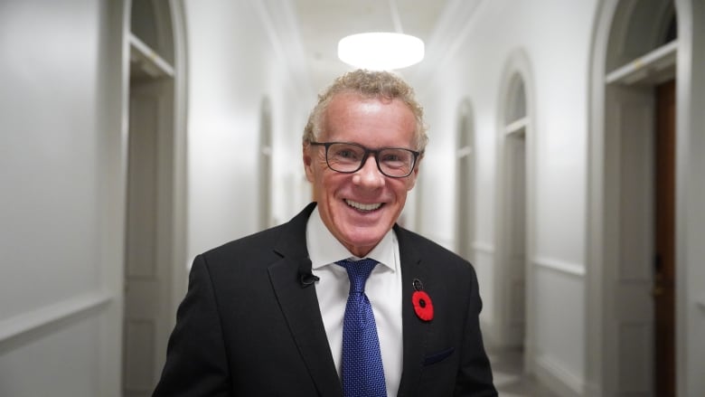 man smiling wearing a suit. 