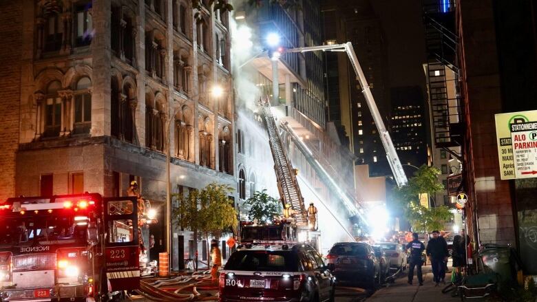 Fire trucks surround burning building 