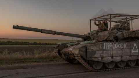 Ukrainian servicemen operate a tank on a road near the border with Russia