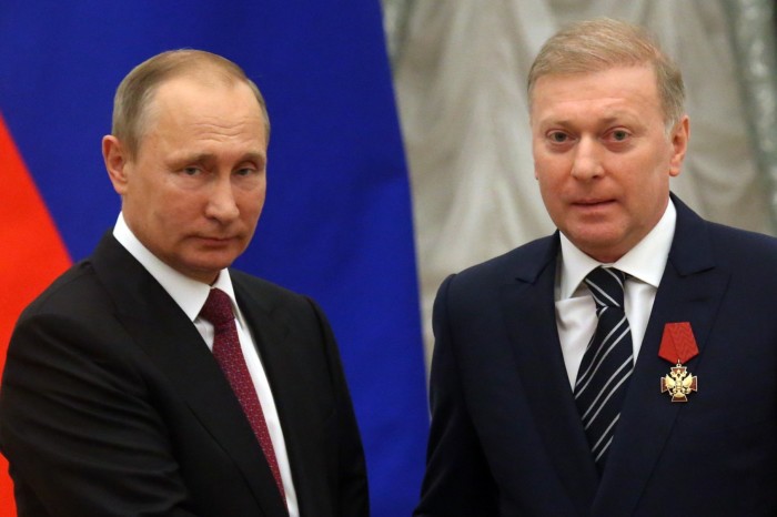 Russian President Vladimir Putin and Musa Bazhaev shake hands 