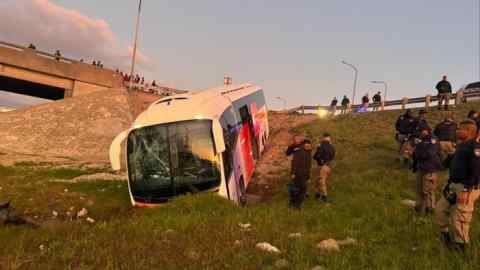 An Intercape bus that had broken through a road barrier to slip down an embankment after being shot at on its way to Cape Town, South Africa in August 2022