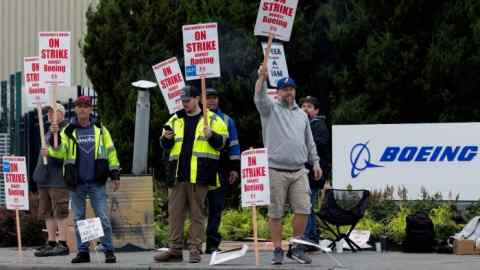 Boeing factory workers gather on a picket line