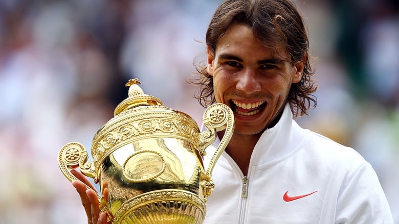 Men's tennis player holds the Championship trophy after winning thesingles final at Wimbledon on July 4, 2010 in London, England.