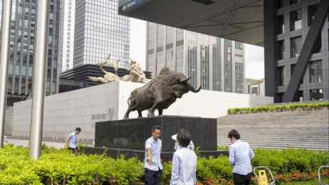 A bull statue in front of the Shenzhen Stock Exchange building