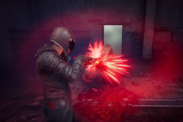 An image from a video game shows a person wearing protective clothing and a crash helmet blasting a creature with a weapon, with fiery results