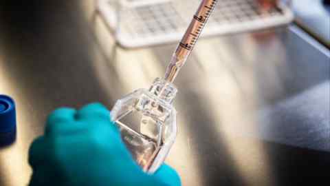 A scientist uses a culture flask and pipette in the cell therapy labs at the Novo Nordisk research facilities in Malov, Denmark