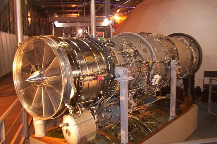 An exposed jet engine on display in a room