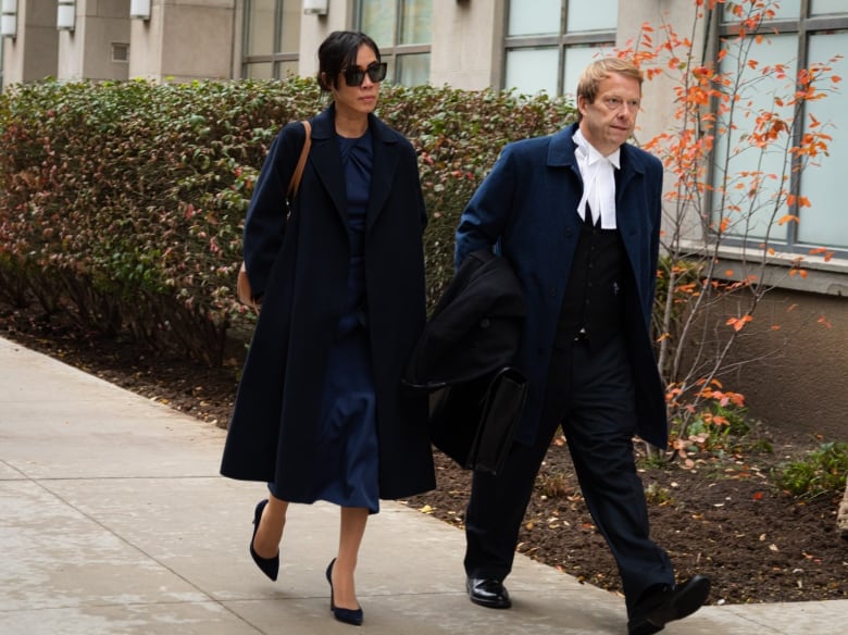 Photo shows suspended lawyer Singa Bui and her lawyer, Andrew Wray, leaving  Superior Court in Toronto on Friday, October 25, 2024.