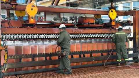 Workers washing copper cathodes at a plant in the El Abra copper mine in Chile