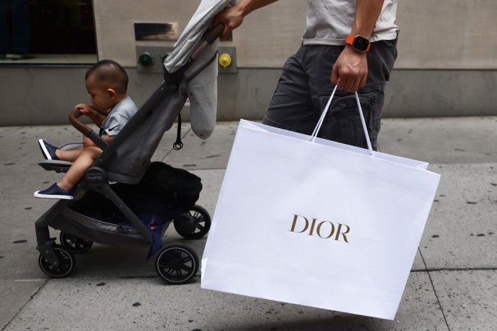 A man with Dior bag and a pram in Manhattan