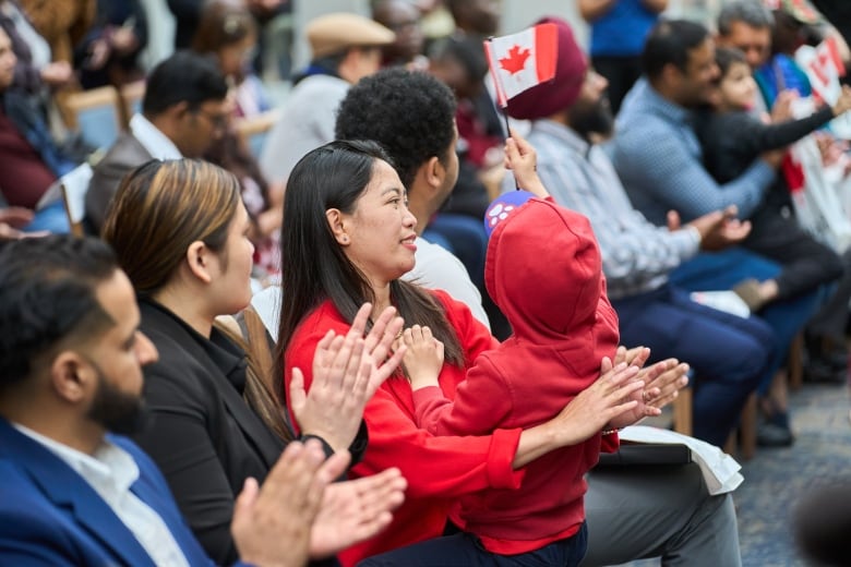 New Canadian citizen Marilou Martin, originally from the Philippines, holds her six-year-old son Kale during a Canada Day citizenship ceremony at the Assiniboine Park Pavilion in Winnipeg, Man. on Monday, July 1, 2024.