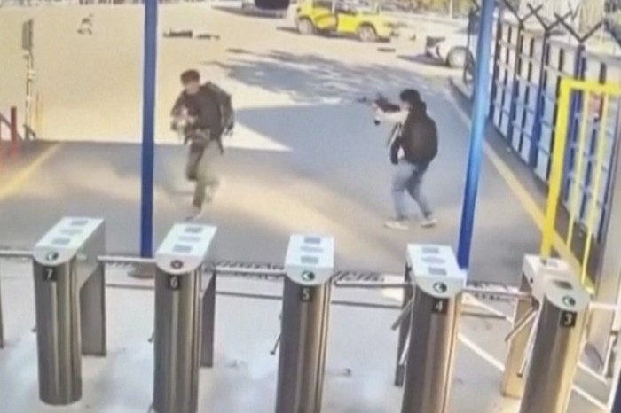 Two people with guns and backpacks during an attack on the premises of the Turkish state-run aerospace and defence company, on the outskirts of Ankara, Turkey