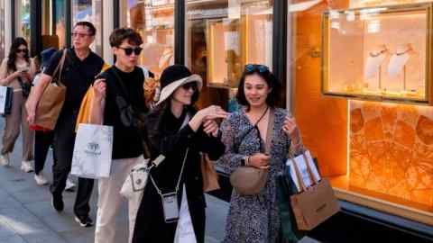 Street scene as shoppers and visitors pass by on Bond Street in the exclusive area of Mayfair