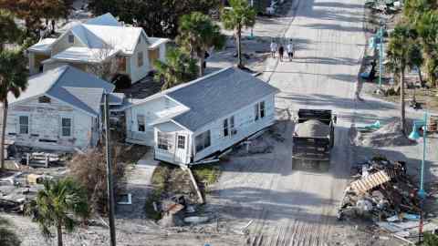 An aerial view of a home sitting on a road following hurricane damage in Manasota Key, Florida, US