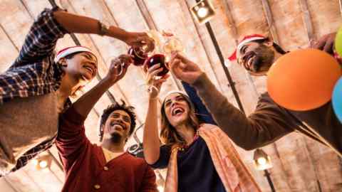 Low angle view of a group of cheerful business people toasting the upcoming New Year