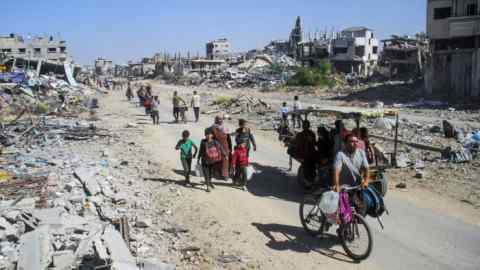 Palestinians flee Jabalia after orders from the Israeli military to evacuate northern Gaza