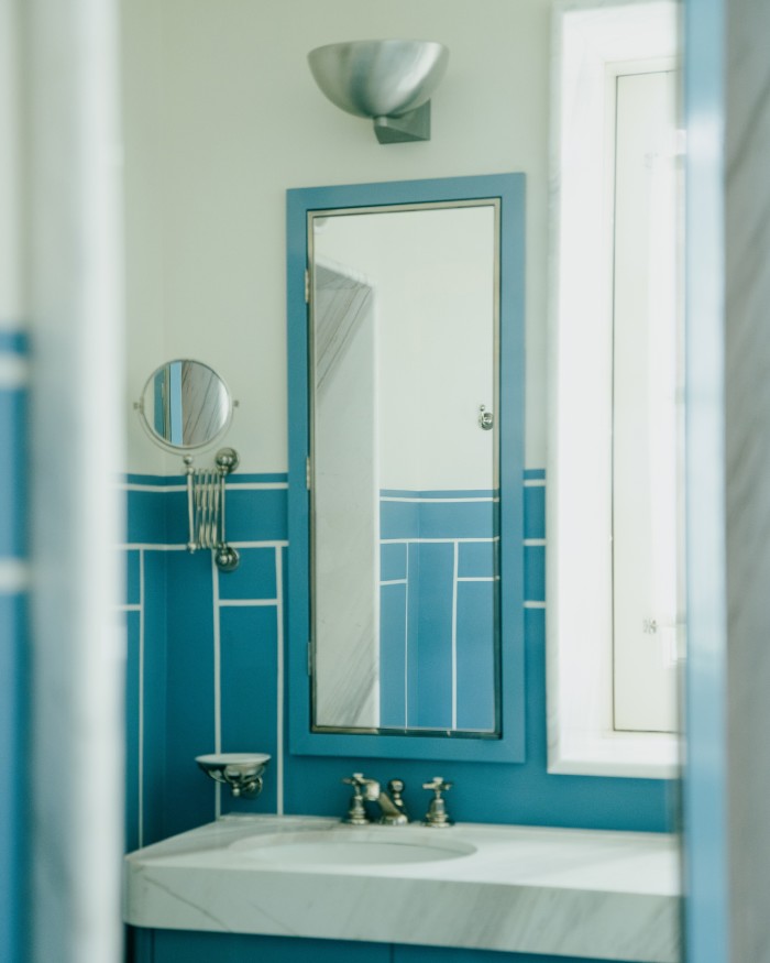 A Bauhaus steel sconce in a bathroom