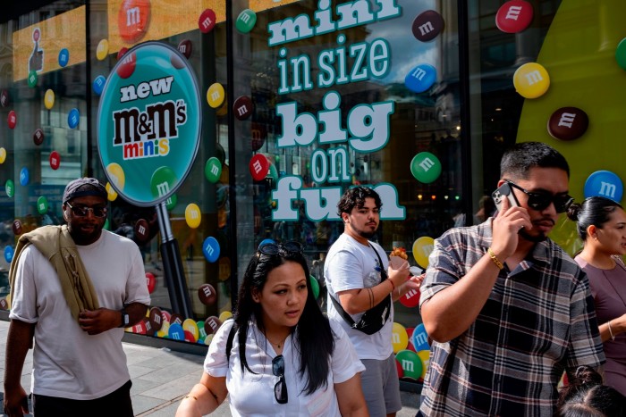 Tourists and domestic visitors in the West End at Leicester Square outside the M&Ms store in London 