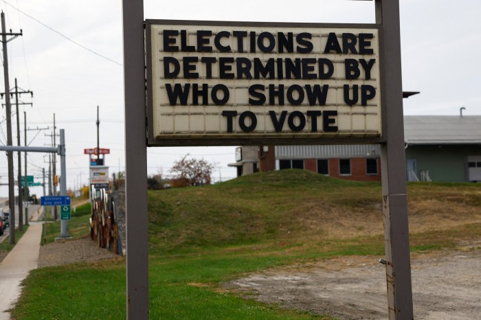 An election voting sign stands along a road in the election battleground city of Erie, Pennsylvania