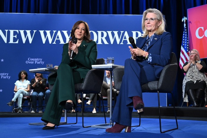 Kamala Harris sits onstage next to Liz Cheney